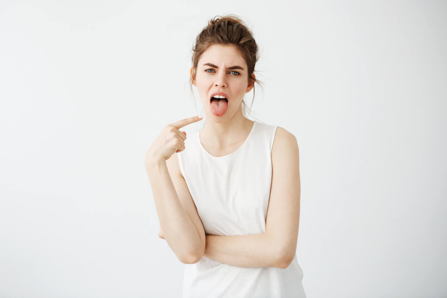 portrait-bored-displeased-young-woman-pointing-finger-her-tongue
